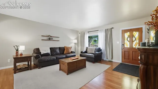 a living room with furniture and a lamp