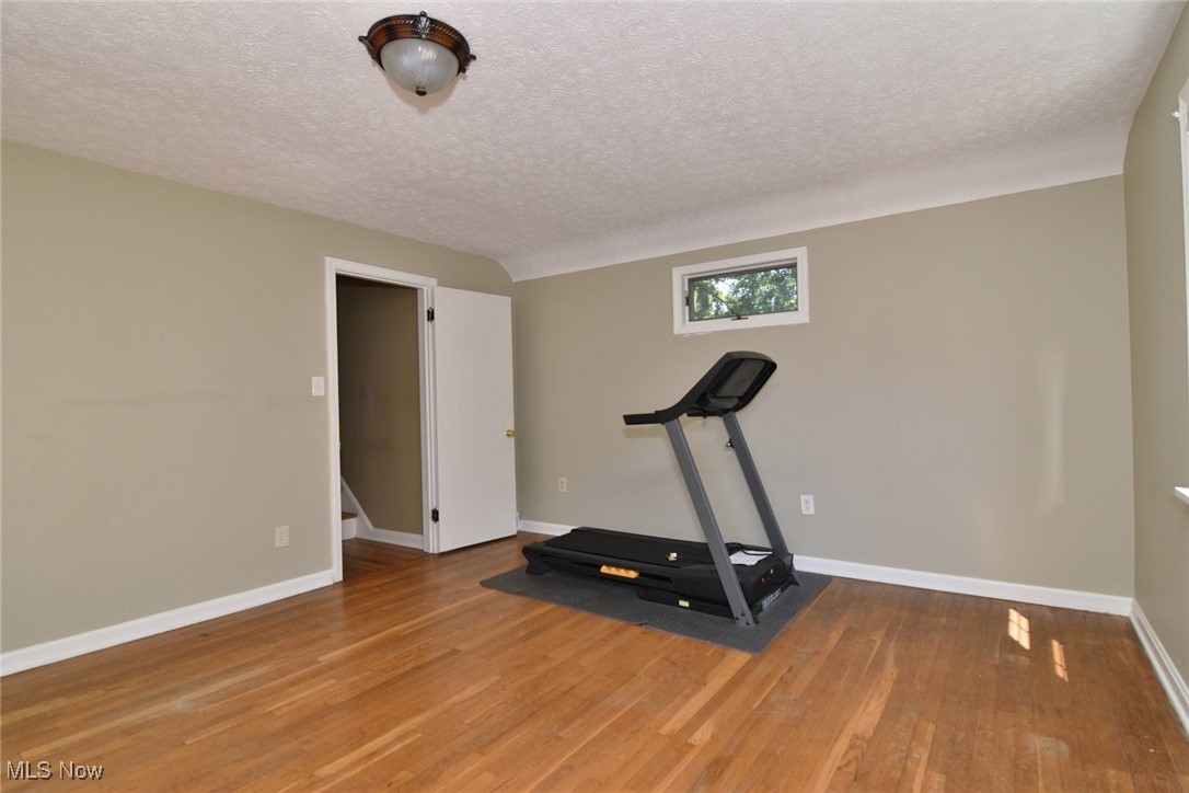 3679 Fenley Road Cleveland Heights, OH 44121 - Photo 32 of 45 Workout room with a textured ceiling and wood finished floors