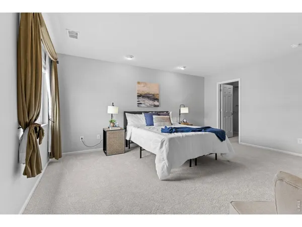 a bedroom with bed and window