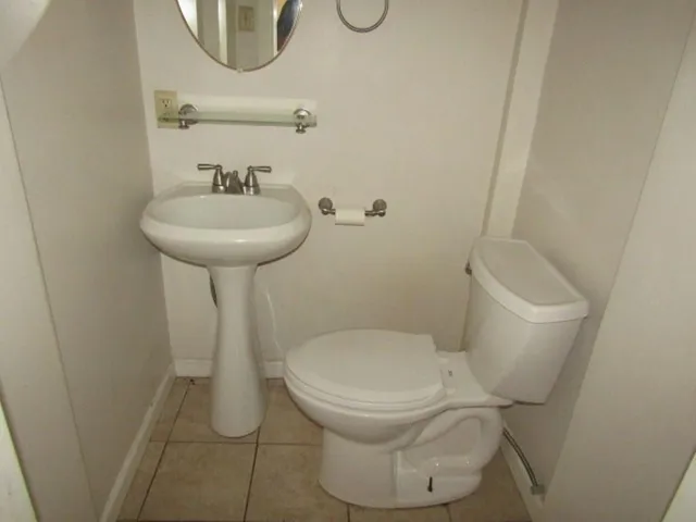 a white toilet sitting next to a bathroom sink