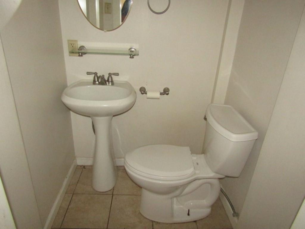 255 Duncan Avenue Washington, PA 15301 - Photo 10 of 39 a white toilet sitting next to a bathroom sink