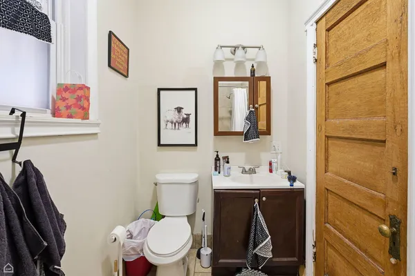 a bathroom with a toilet sink and mirror