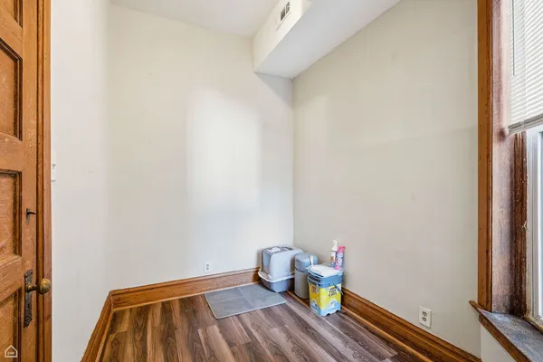 a bathroom with a wooden floor and toilet