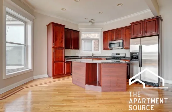 a kitchen with stainless steel appliances granite countertop a refrigerator and a stove top oven
