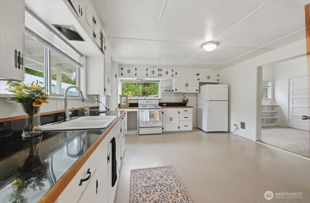 23746 Old Day Creek Road, Unit A & B Sedro-Woolley, WA 98284 - Photo 12 of 36 a kitchen with refrigerator and cabinets