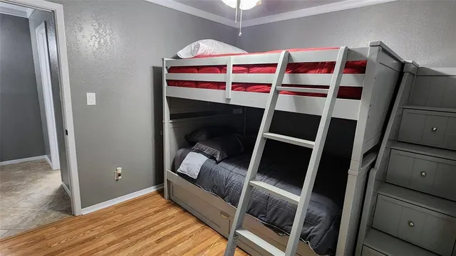 a bedroom with a bunk bed and a chair