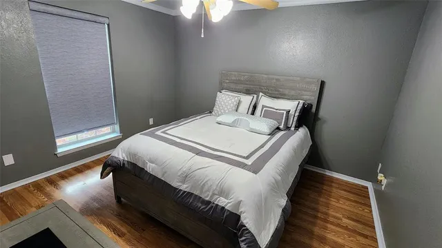 a bed sitting in a bedroom next to a window