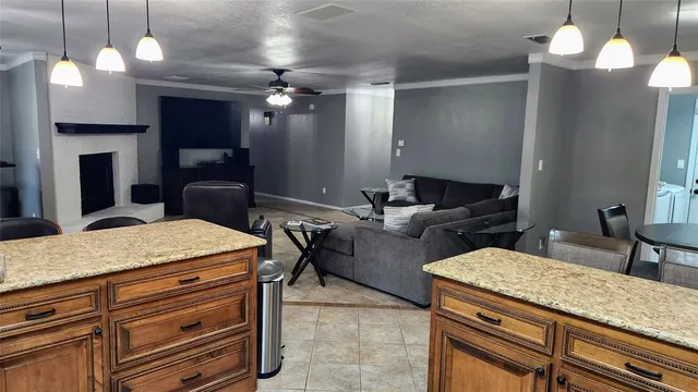 a bathroom with a granite countertop sink a toilet and a mirror