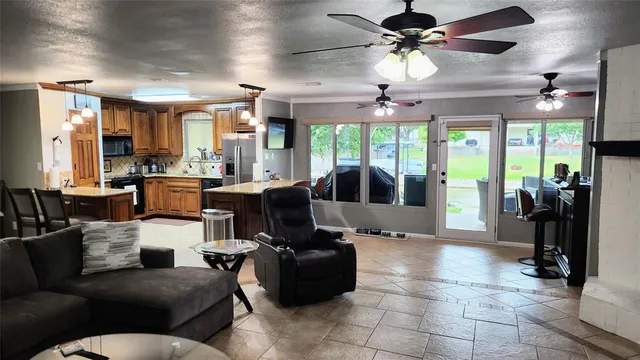 a living room with furniture and a chandelier