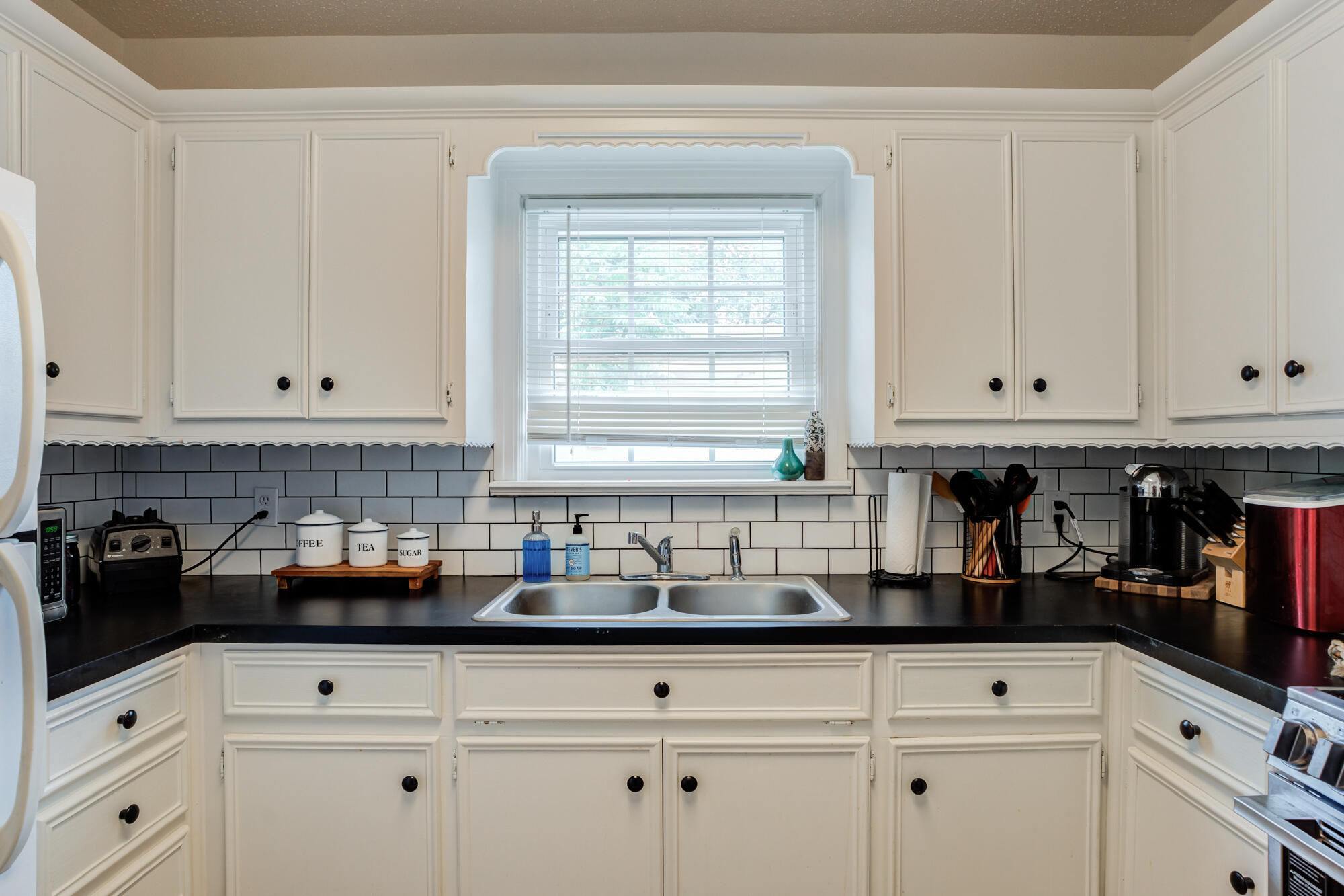 2826 33rd Street Lubbock, TX 79410 - Photo 21 of 33 a kitchen with white cabinets and window