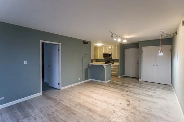a view of a kitchen with a sink and a refrigerator