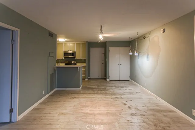 a view of a kitchen with a sink and a refrigerator