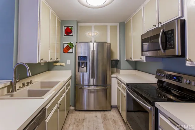 a kitchen with a sink stove and refrigerator