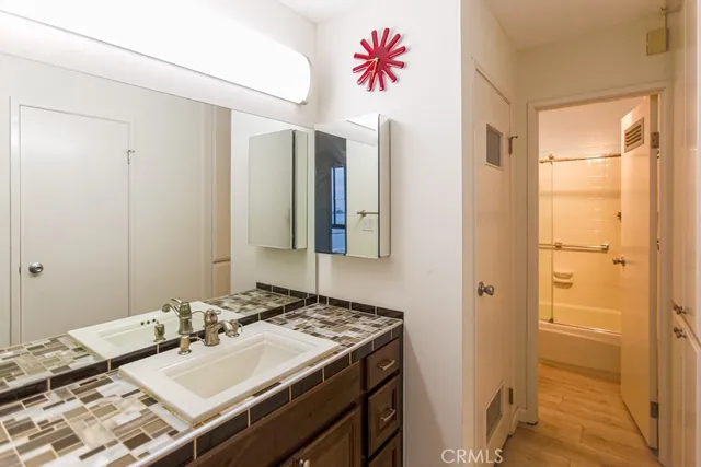 a bathroom with a sink vanity and a mirror