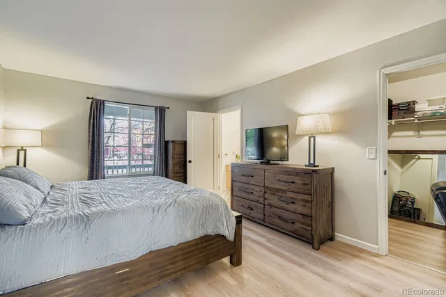 a bedroom with a bed and a tv on table
