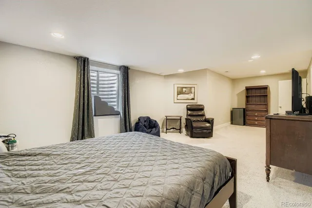 a large bedroom with a bed and furniture