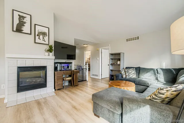 a living room with furniture flat screen tv and a fireplace