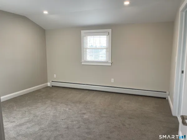 a kitchen with cabinets appliances and wooden floor