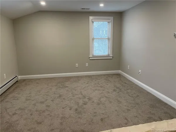 an empty room with a empty space and windows