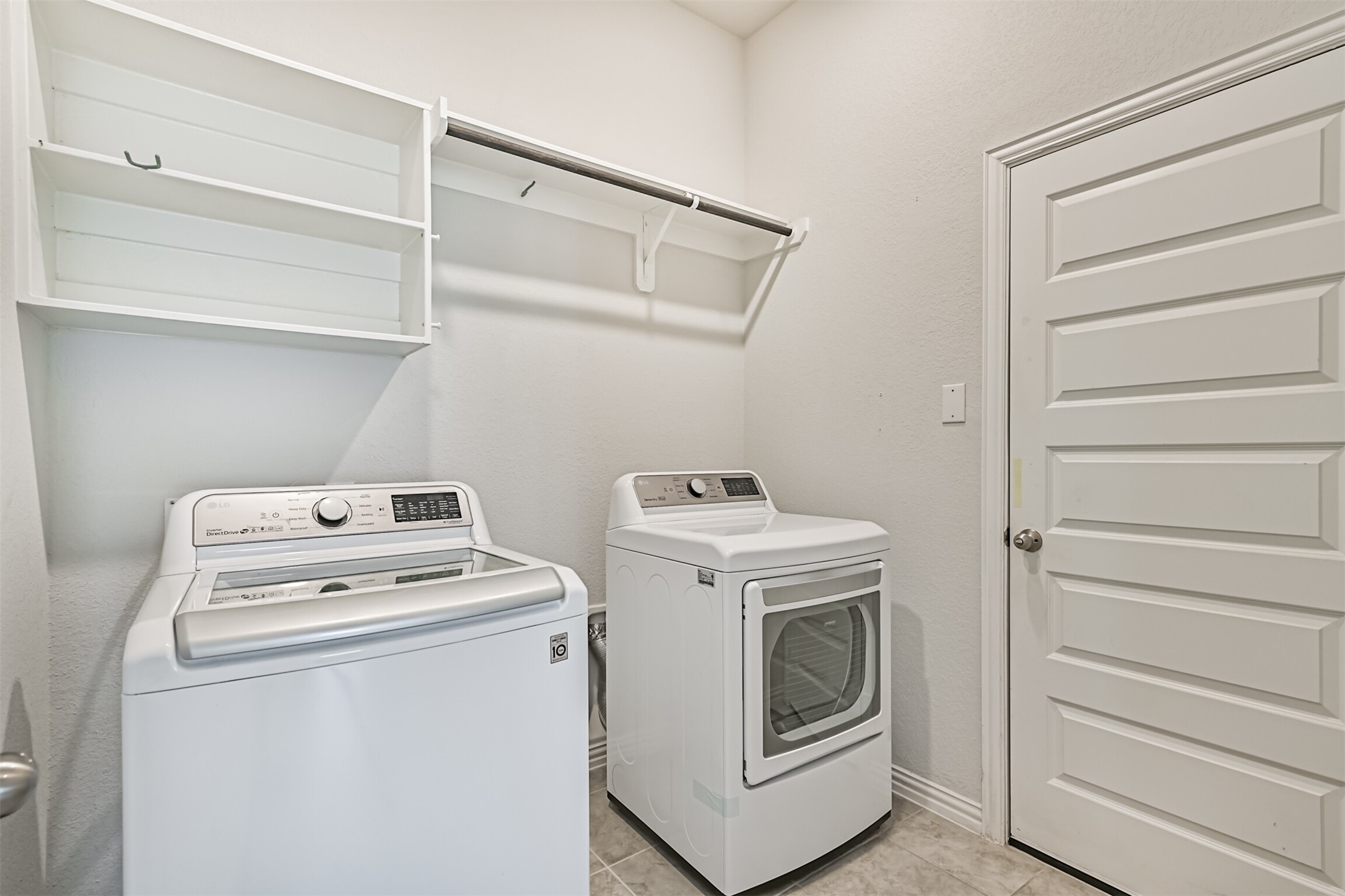 7019 Terra Drive Manvel, TX 77578 - Photo 9 of 41 a view of storage and utility room with washer and dryer