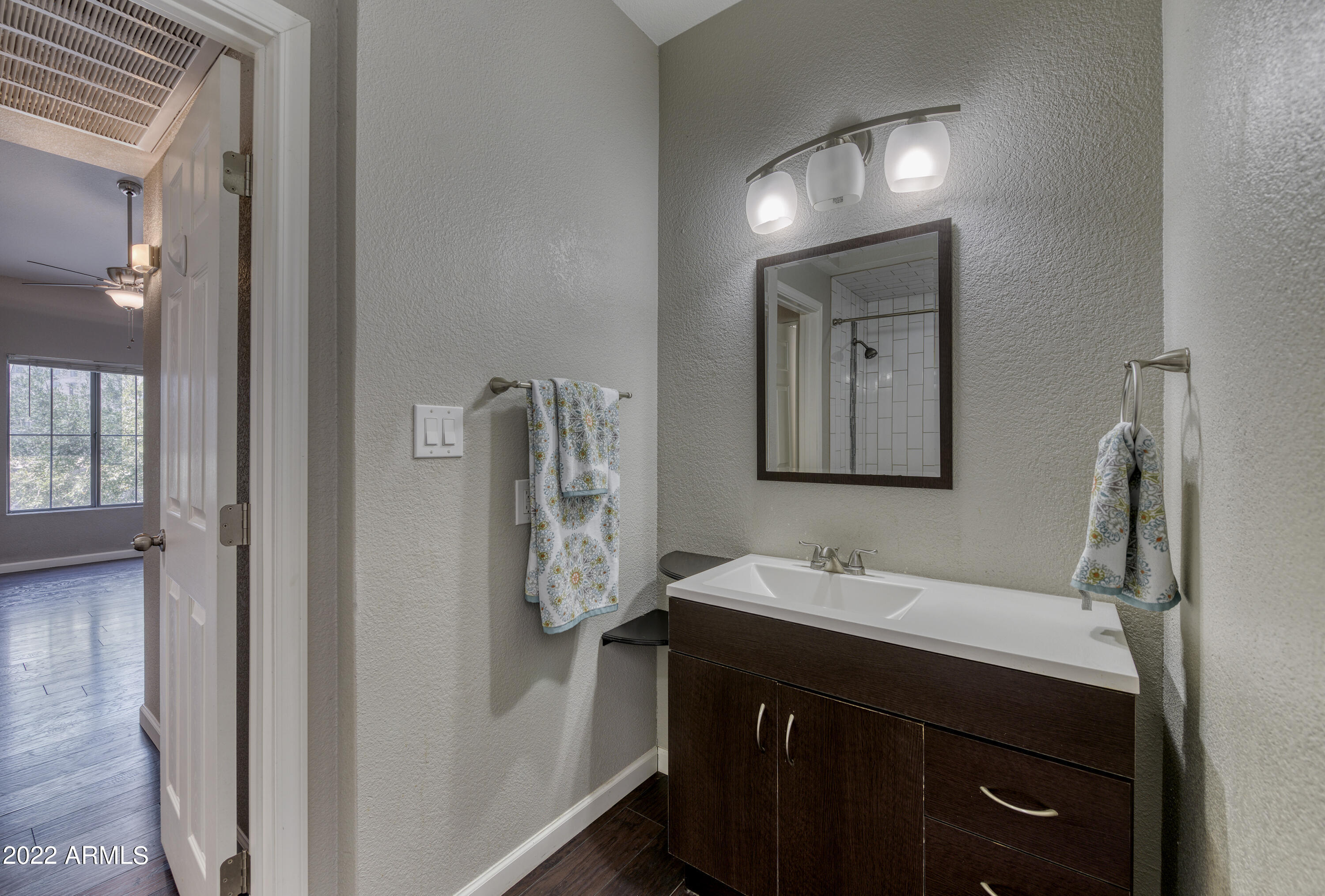 100 East Fillmore Street, Unit 201 Phoenix, AZ 85004 - Photo 15 of 23 a bathroom with a sink and a mirror