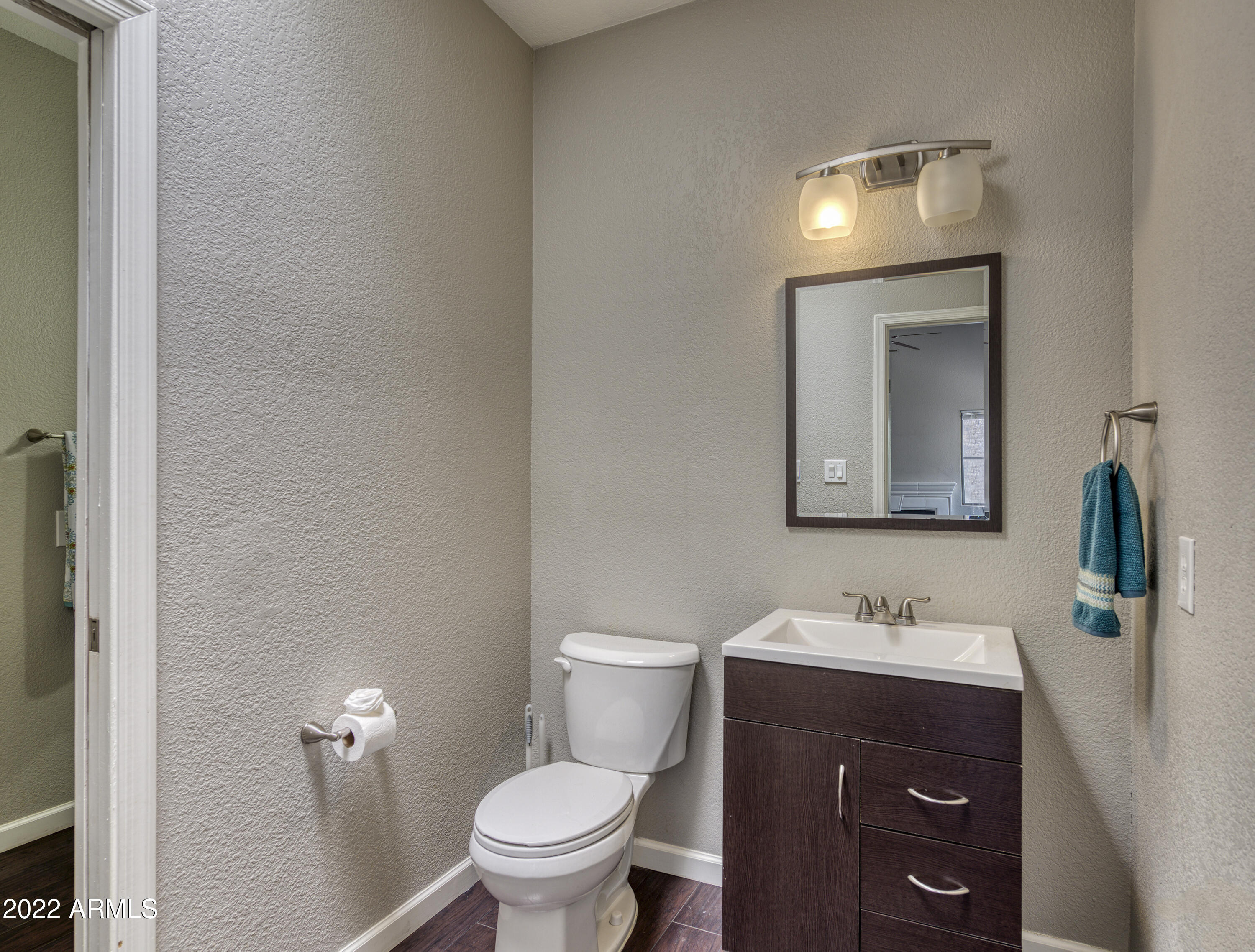 100 East Fillmore Street, Unit 201 Phoenix, AZ 85004 - Photo 20 of 23 a bathroom with a toilet sink and mirror