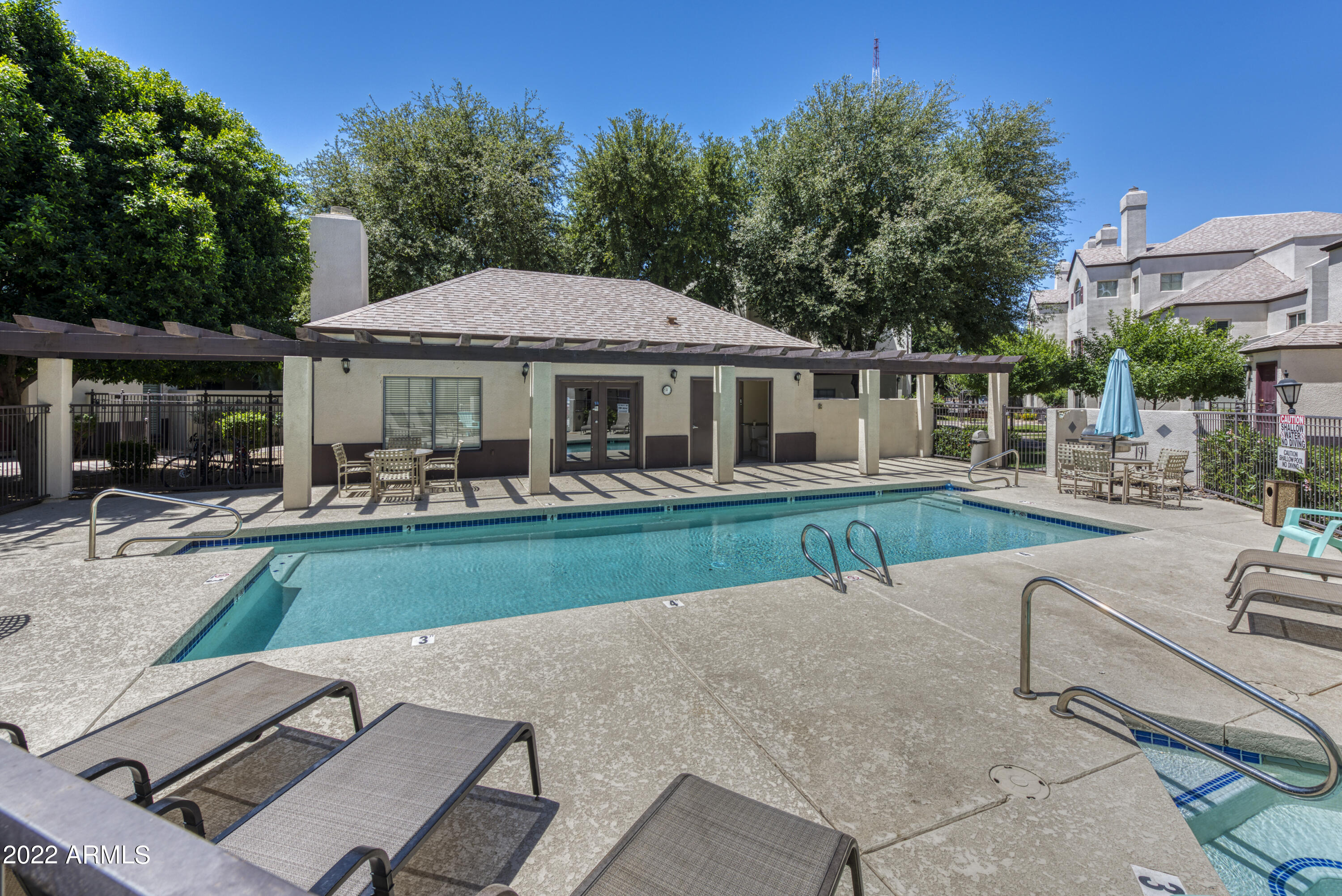 100 East Fillmore Street, Unit 201 Phoenix, AZ 85004 - Photo 21 of 23 a view of patio with table and chairs under an umbrella