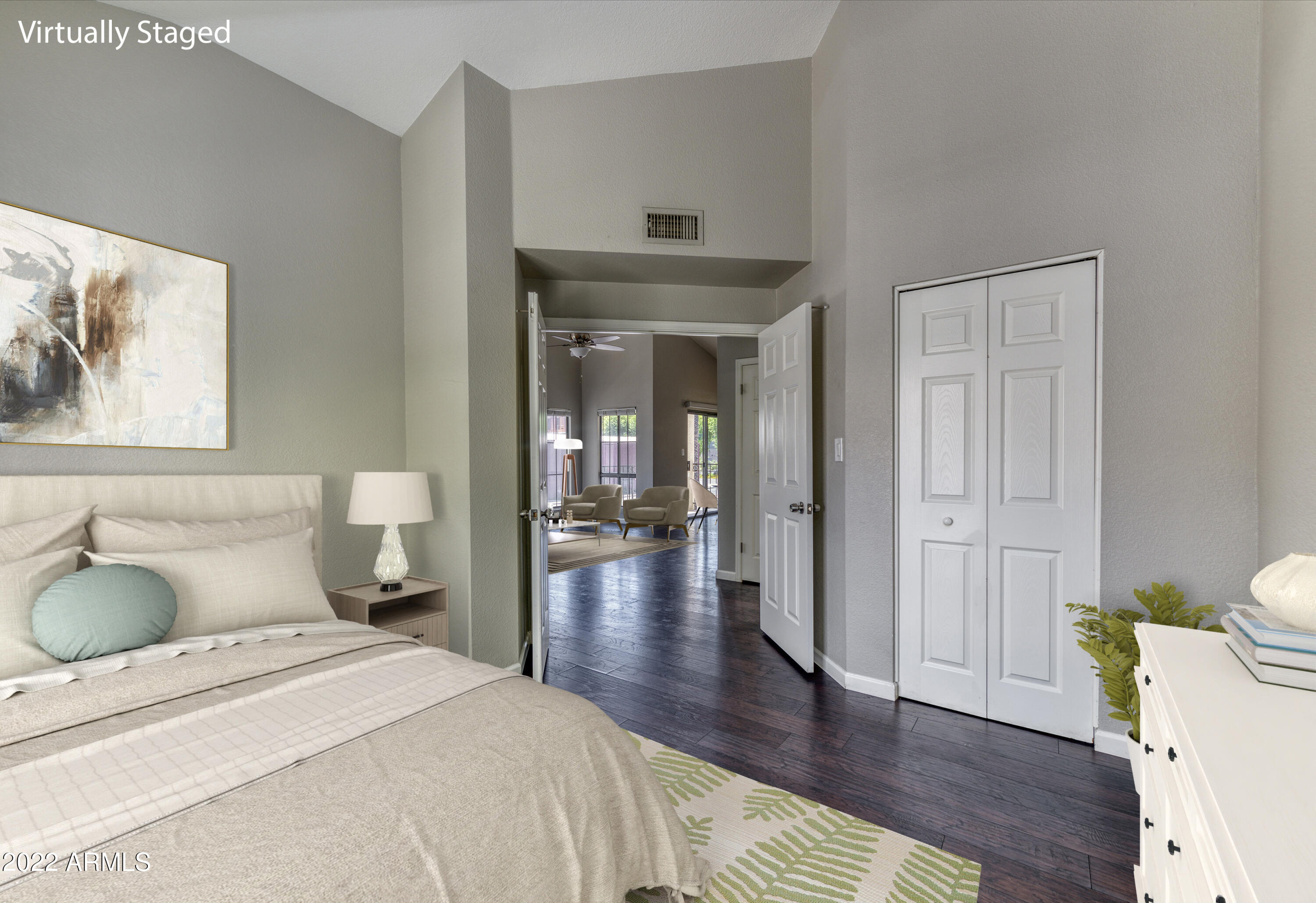 100 East Fillmore Street, Unit 201 Phoenix, AZ 85004 - Photo 5 of 23 a spacious bedroom with a bed and wooden floor