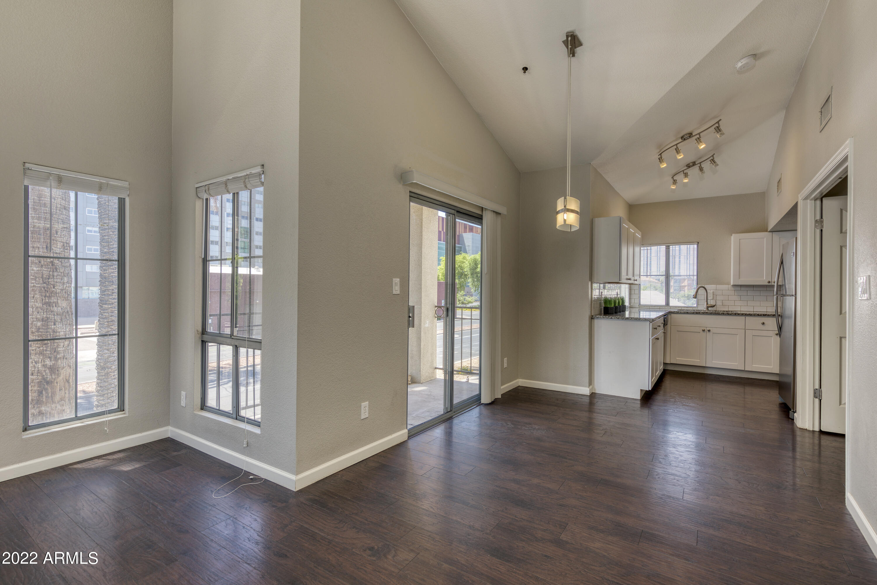 100 East Fillmore Street, Unit 201 Phoenix, AZ 85004 - Photo 10 of 23 a view of a big room with wooden floor and a kitchen