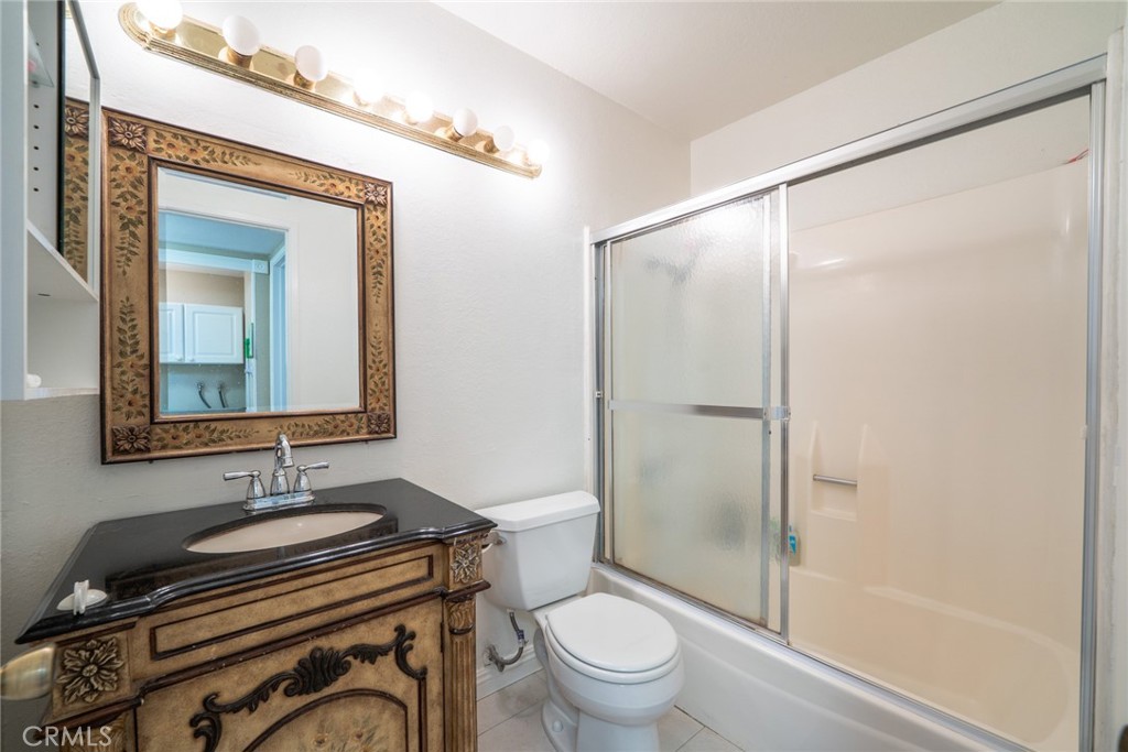 45 Oval Irvine, CA 92604 - Photo 21 of 40 a bathroom with a granite countertop sink toilet a mirror and shower