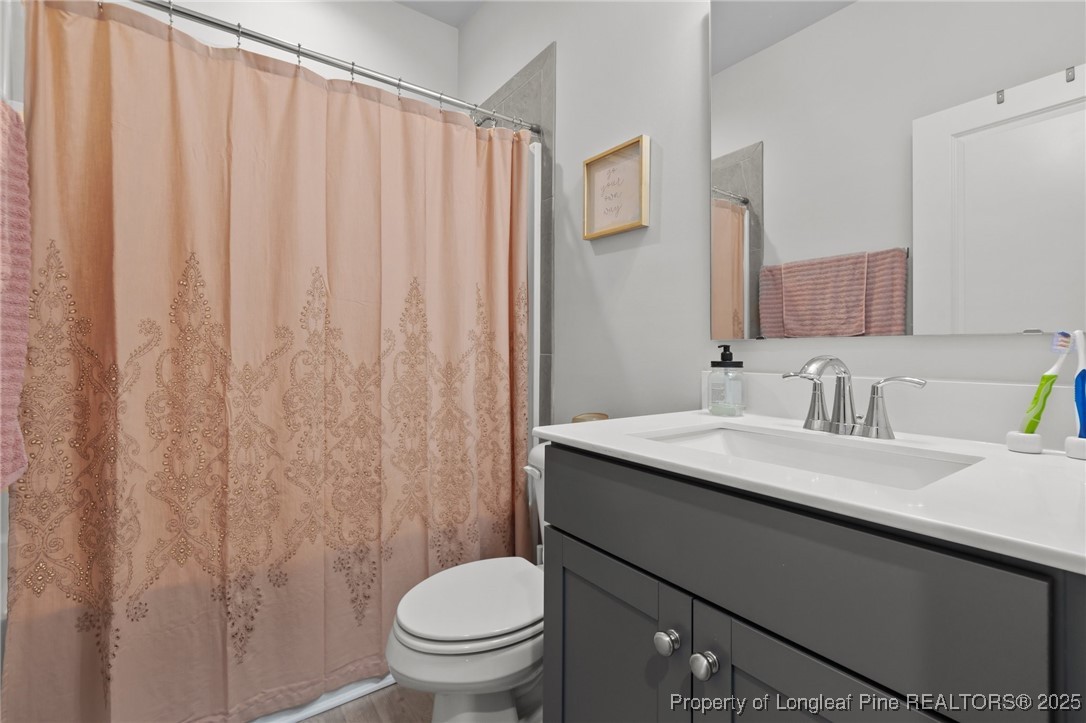 1660 Stackhouse Drive Fayetteville, NC 28314 - Photo 21 of 44 a bathroom with a granite countertop sink and a toilet