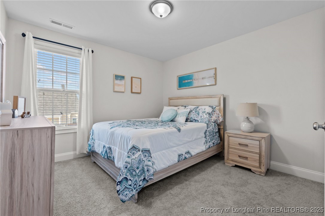 1660 Stackhouse Drive Fayetteville, NC 28314 - Photo 24 of 44 a bedroom with a bed and a window
