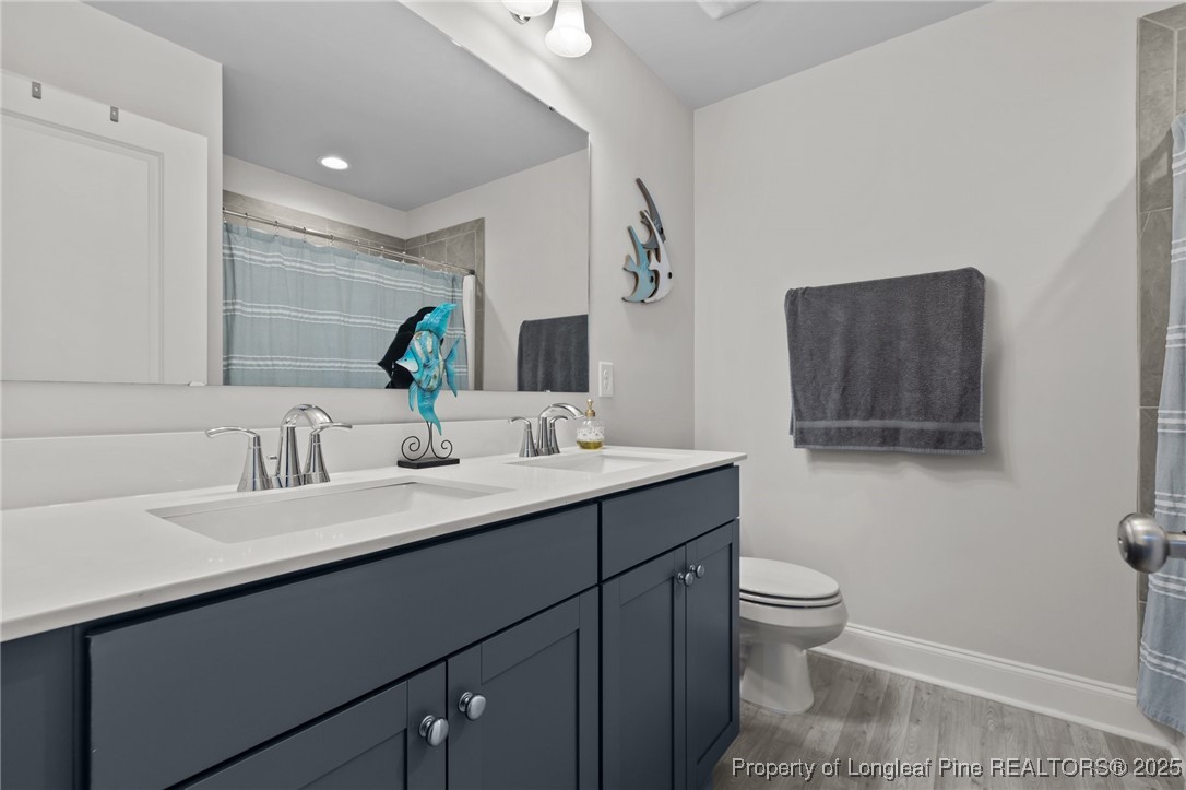 1660 Stackhouse Drive Fayetteville, NC 28314 - Photo 25 of 44 a bathroom with a sink double vanity and a toilet