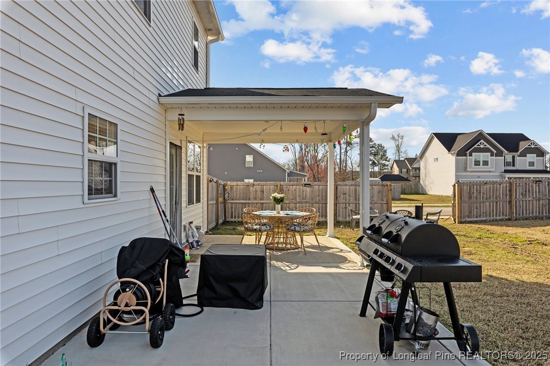 1660 Stackhouse Drive Fayetteville, NC 28314 - Photo 36 of 44 a view of a patio with table and chairs and potted plants