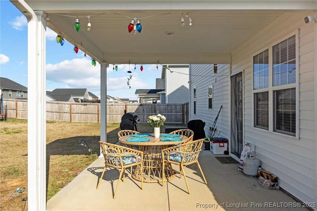 1660 Stackhouse Drive Fayetteville, NC 28314 - Photo 37 of 44 a dining room with furniture and a floor to ceiling window