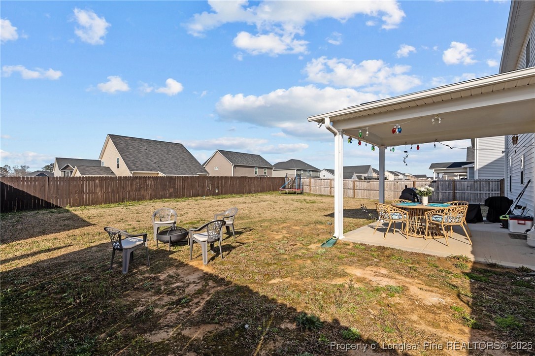1660 Stackhouse Drive Fayetteville, NC 28314 - Photo 38 of 44 a view of a patio with table and chairs