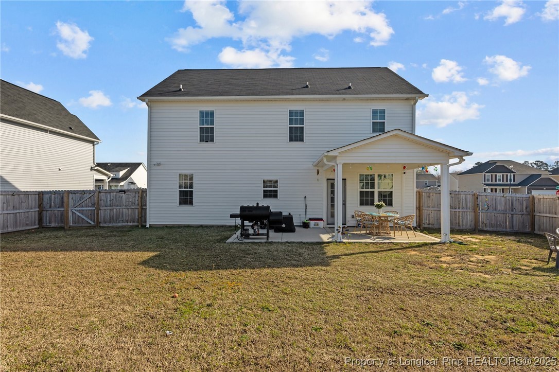 1660 Stackhouse Drive Fayetteville, NC 28314 - Photo 44 of 44 a backyard of a house with table and chairs