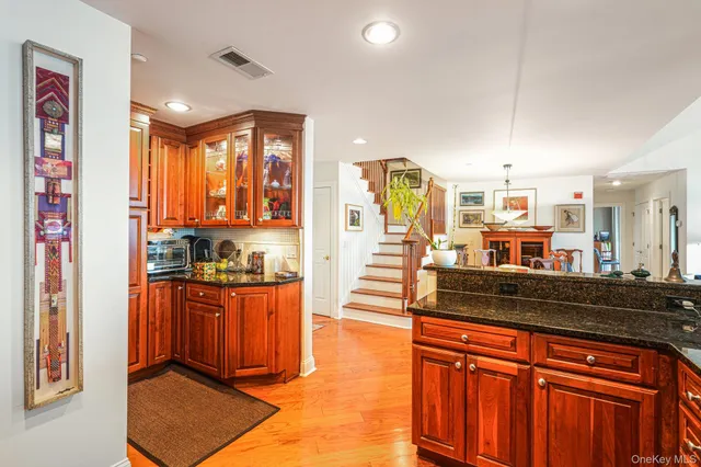 a kitchen with stainless steel appliances granite countertop a stove a sink and a refrigerator