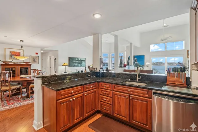 a kitchen with stainless steel appliances granite countertop sink stove and cabinets