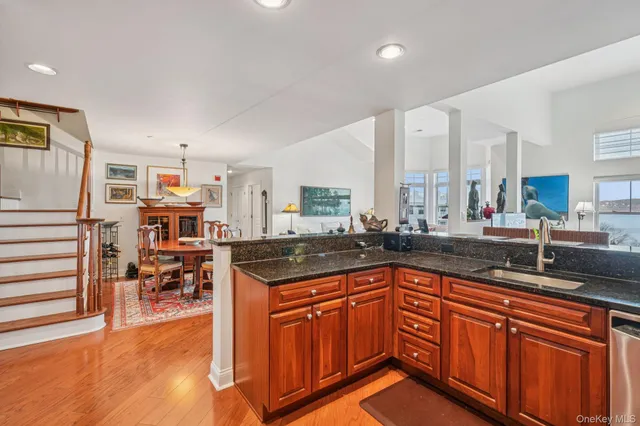 a kitchen with stainless steel appliances granite countertop a sink and cabinets