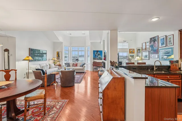 a living room with stainless steel appliances kitchen island granite countertop furniture and a kitchen view