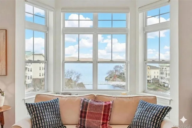 a living room with furniture and large windows