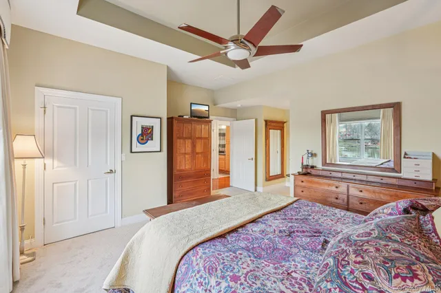 a bedroom with a large bed and a chandelier