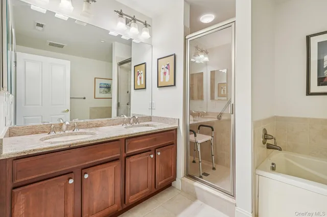 a spacious bathroom with a granite countertop sink mirror and shower