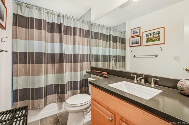 a bathroom with a sink a toilet a shower and a mirror