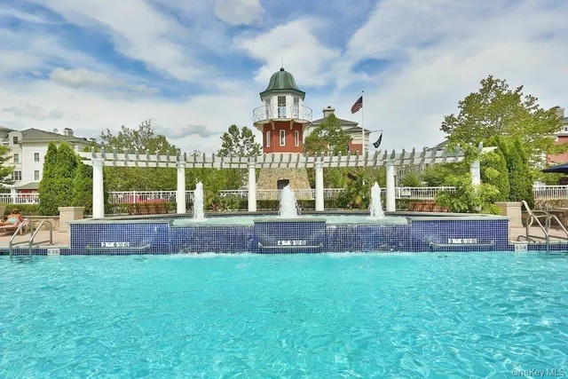 a view of a house with a big yard and large trees