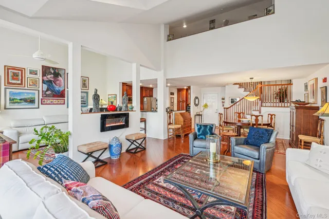 a living room with furniture kitchen view and a large window