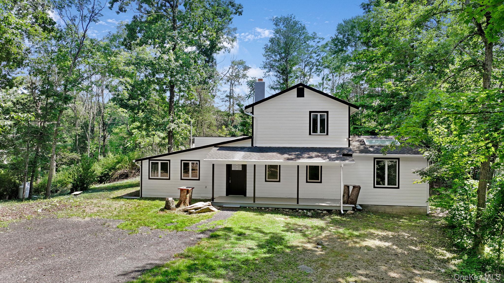 26 Carter Road Pleasant Valley, NY 12569 - Photo 1 of 1 Back of house with a porch, a chimney, a yard, and roof with shingles
