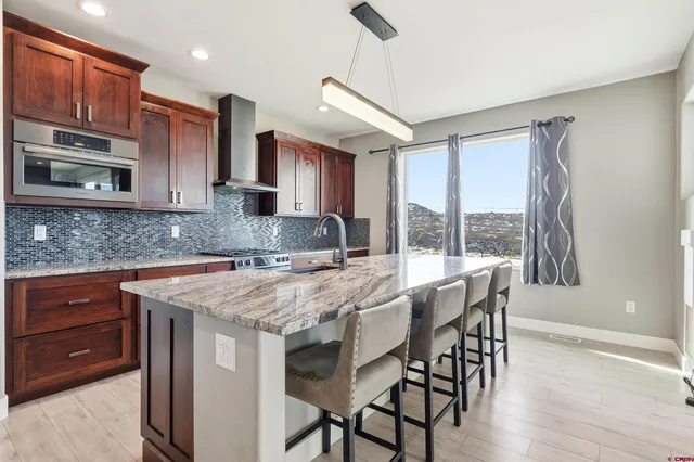 a kitchen with a stove a sink and a refrigerator