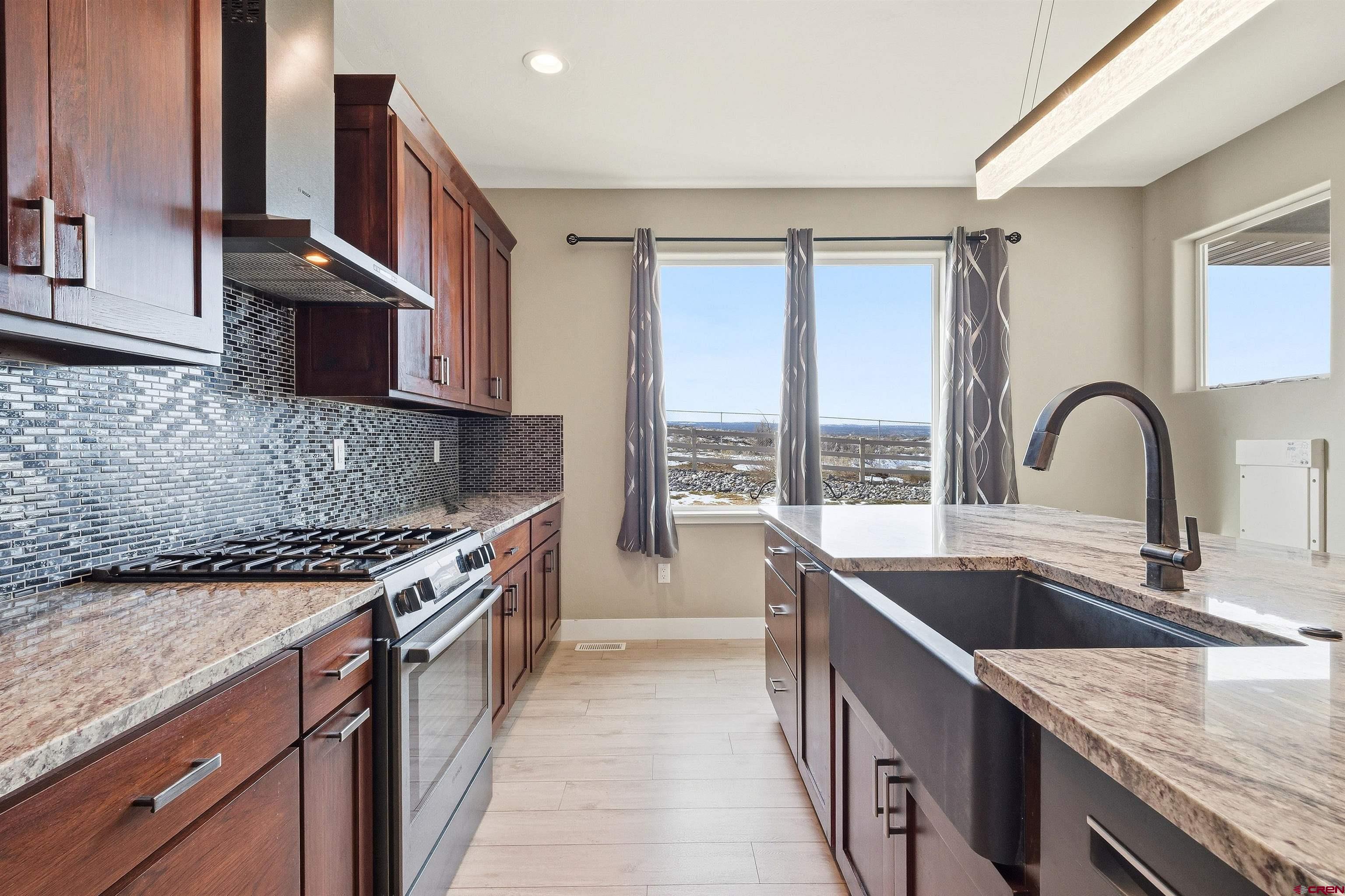 3614 Ridgeline Drive Montrose, CO 81401 - Photo 12 of 45 a kitchen with stainless steel appliances granite countertop a sink stove and cabinets